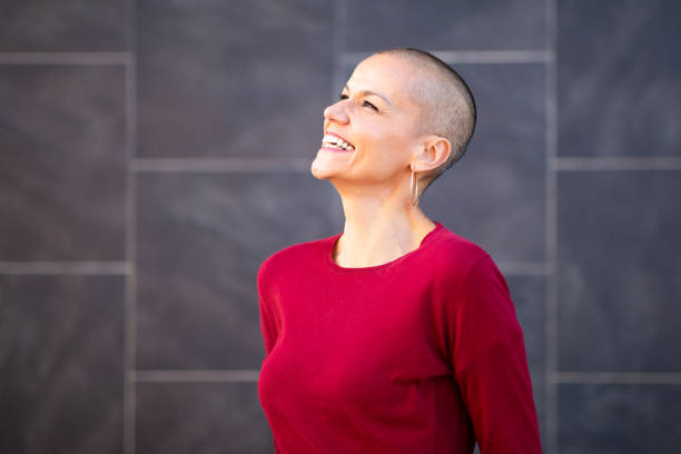 istock smiling middle age woman with shaved head 2199472051