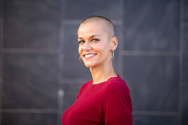 istock smiling woman with short shaved hair 2199472069