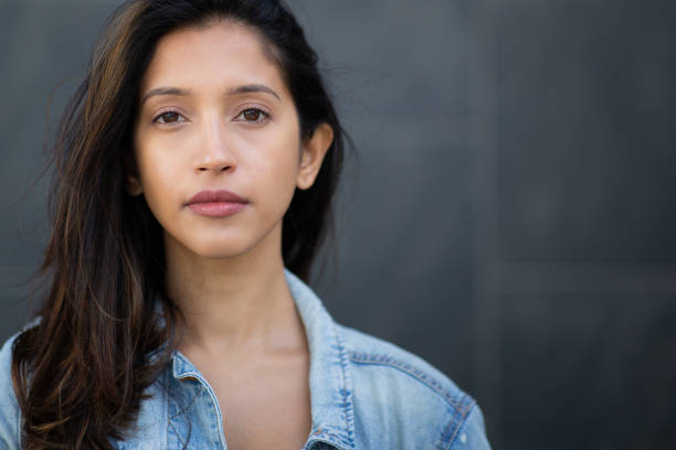 istock Close up young woman with serious face expression staring 2199472424