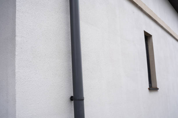 istock White building wall with gray downspout and narrow window details 2199472534