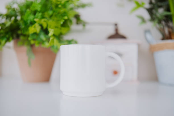 istock Warm ceramic mug placed on a table among indoor plants 2199472594