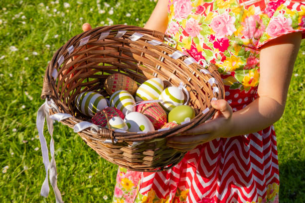 Child carrying basket painted Easter eggs, Traditional Easter egg hunt, spring holiday, celebration mood, seasonal fun activity, holiday and family themes