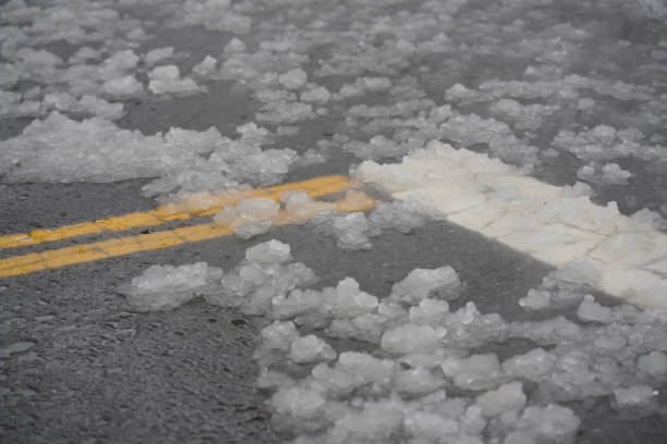 istock Wet Snowy Conditions on Roadway Intersection During Winter Storm 2199475663