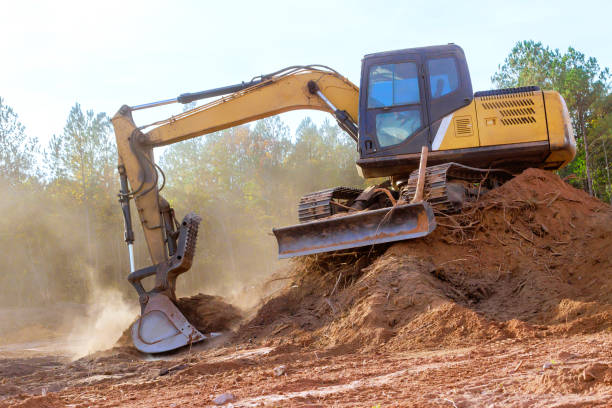 istock Excavator working on construction site surrounded by work equipment is actively earth moving 2199476372