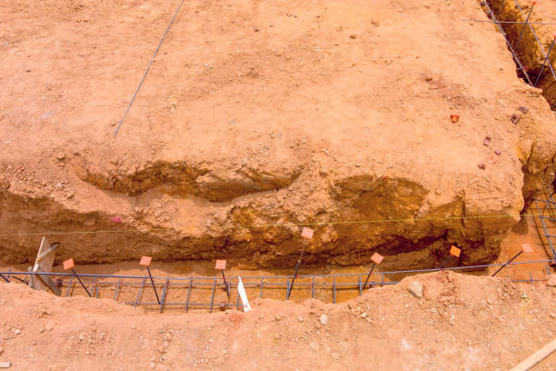 istock Excavation site showing foundation work with rebar detail at construction location during daylight 2199476497