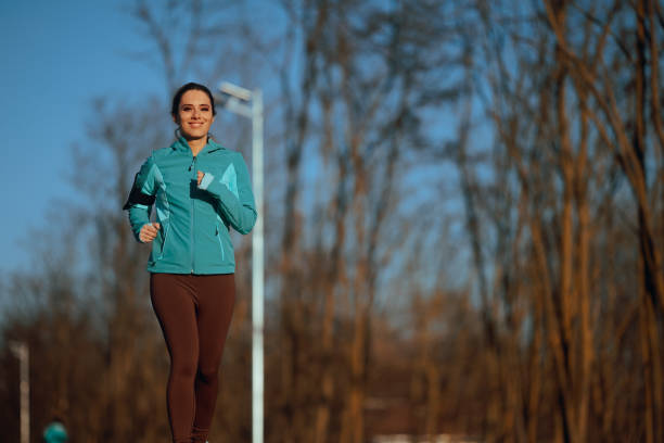 Carefree woman having fun exercising outdoors in nature