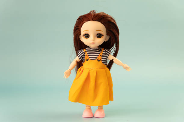 A detailed view of a doll dressed in a bright red coat, ideal for use in children's illustrations or advertising.