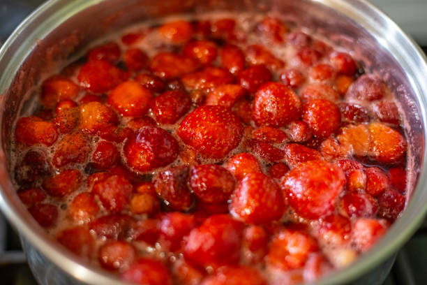 istock A nickel-plated saucepan with strawberries boiled in sugar syrup. Fruit preservation, jam 2199485678