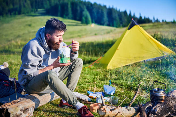 istock Bearded man eating from food pouch 2199486355