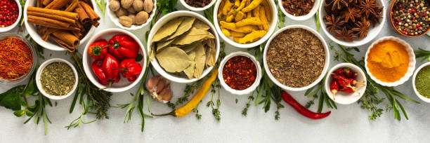 istock Assorted cooking spices and herbs arranged on a gray surface, featuring natural tones that add depth and aroma to any meal, banner 2199487678