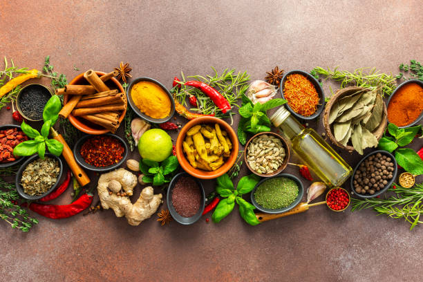istock A stunning spread of fresh spices and herbs, meticulously arranged on a deep brown backdrop, capturing their vibrant colors and tantalizing aromas 2199487719