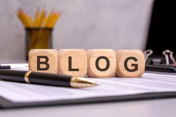 istock wooden cubes spelling BLOG on an office desk, symbolizing content creation, writing, and marketing 2199488873