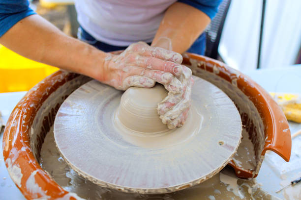 istock Mastering pottery by shaping clay on a wheel in a bright studio 2199489029