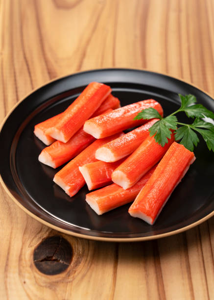 istock Imitation Crab Sticks on a Wooden Table 2199491781