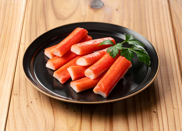 istock Imitation Crab Sticks on a Wooden Table 2199491786
