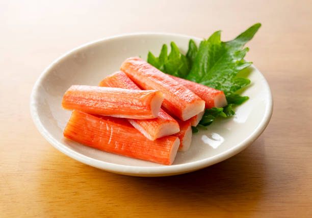 istock Imitation Crab Sticks on a Wooden Table 2199491796