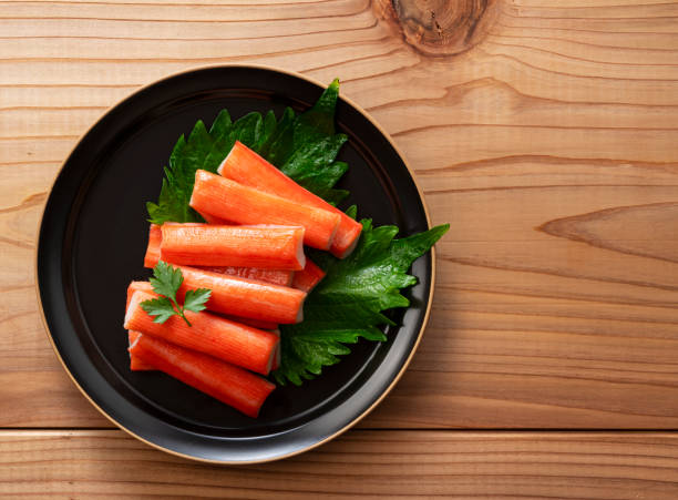 istock Top View of Imitation Crab Sticks on a Wooden Table 2199491806