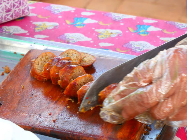 istock Hands slicing sausages on a cutting board. 2199495729