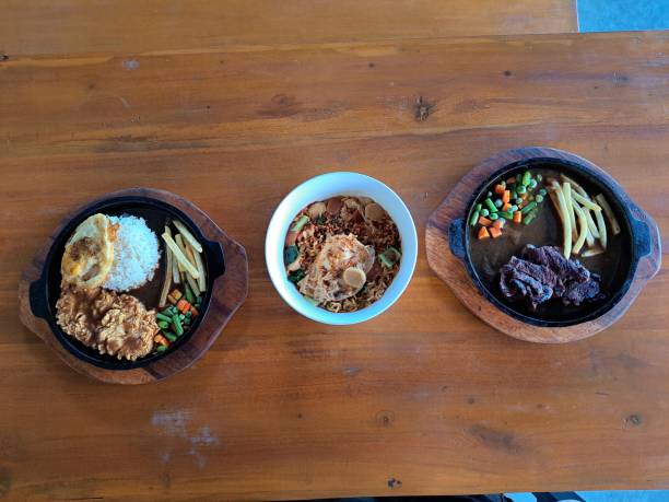 istock Crispy Rice Egg Chicken Steak, Mi Goreng Telur Or Fried Noodle Egg And Pan Seared Beef Steak. Food Menu. Top View. 2199496273