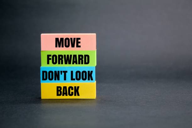istock colored paper with the words move forward don't look back. the concept of self-motivation. the concept of going in the direction of goodness 2199499341