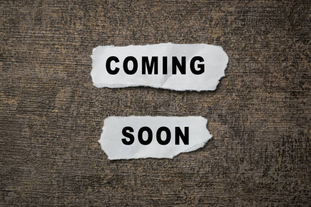 istock coming soon words text message on torn paper on dark background 2199503892