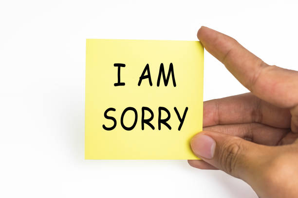 istock male hand holding sticky notes with i am sorry words message on white background 2199507208