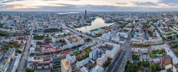 Yekaterinburg city and pond aerial panoramic view at summer sunset. View from Vysotsky skyscraper Yekaterinburg city and pond aerial panoramic view at summer sunset. View from the observation deck on the 52nd floor of Vysotsky skyscraper. Yekaterinburg, Russia russia city spring stock pictures, royalty-free photos & images