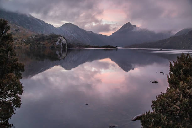 istock Serene dawn at Dove Lake with Cradle Mountain peaks, tranquil reflections, and misty clouds in Tasmania, Australia 2199517494