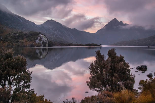 istock Serene dawn at Dove Lake with Cradle Mountain peaks, tranquil reflections, and misty clouds in Tasmania, Australia 2199517537