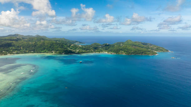 istock Clear turquoise bay surrounded by lush green hills. 2199519992