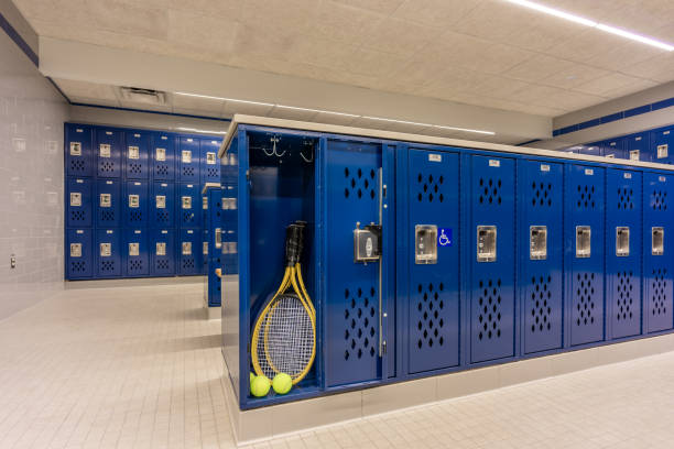 istock Empty team locker, locker room, changing room, with an open locker containing tennis racket tennis balls, with traditional blue metal lockers. 2199520720
