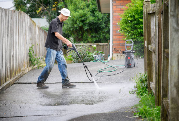 istock Man washing concrete driveway using a pressure washer. 2199523317