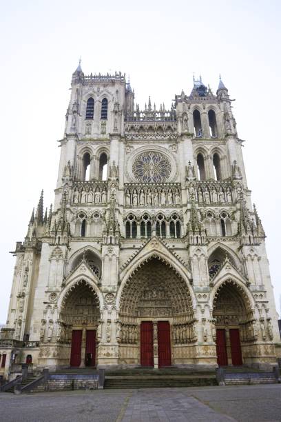 istock Amiens Cathedral front view with Gothic details and red doors 2199524379