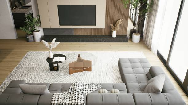 istock A modern living room featuring a stylish gray sectional sofa, a wooden coffee table, and decorative plants, all complemented by natural light. 3d rendering. 2199526079