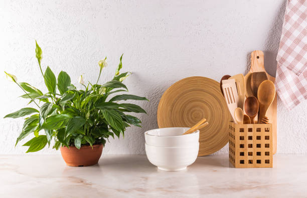 istock Beautiful kitchen background with wooden eco-friendly kitchen tools, utensils, potted plant. Front view. Stylish kitchen. Zero waste house concept 2199527531