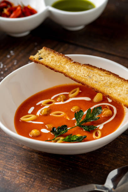 istock Tomato soup with pasta, roasted chickpeas, cream, and toast on top 2199530588