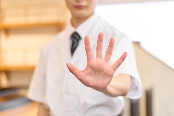 A male Japanese chef trying to stop