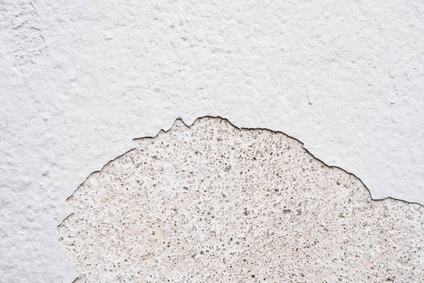 istock White Paint peel off, Broekn cracking concrete wall interior, Old Grey wall building construction with torn texture.Outdoor architecture with grunge plaster peeling. Cement floor with grain surface 2199532177