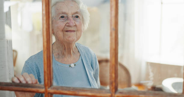 istock Thinking, window and calm with old woman in living room for memory, reflection and mindfulness. Peace, inspiration and vision with senior person in nursing home for retirement, decision and wonder 2199532997