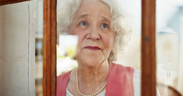 istock Thinking, window and smile with old woman in living room for memory, reflection and mindfulness. Peace, inspiration and vision with senior person in nursing home for retirement, decision and wonder 2199533064
