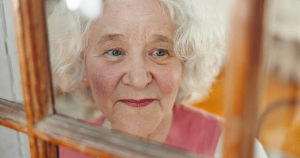 istock Thinking, window and morning with old woman in house for memory, reflection and mindfulness. Peace, inspiration and vision with senior person in nursing home for retirement, decision and happy 2199533090