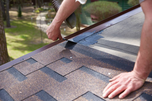istock Worker's hands are smeared with waterproofing mastic for the roof. 2199533118