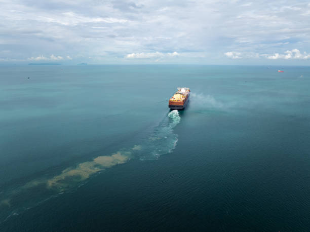 istock cargo container ship carrying sailing in sea import export goods and distributing products to dealer consumers across Asia pacific and worldwide global business transportation by container ship, rear view 2199540582