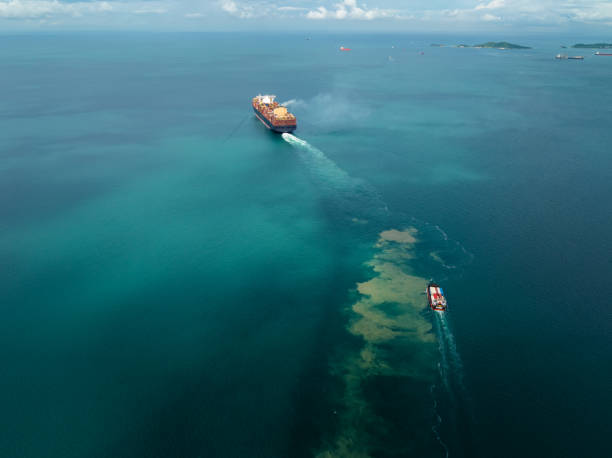 istock cargo container ship carrying sailing in sea import export goods and distributing products to dealer consumers across Asia pacific and worldwide global business transportation by container ship, rear view 2199540593