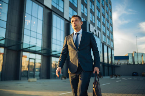 istock Professional lawyer standing outside a grand office building. 2199541264