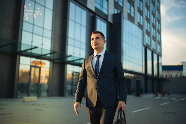 istock Professional lawyer standing outside a grand office building. 2199541273