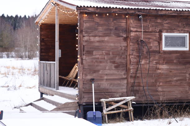 istock A small wooden cabin with a door and a window 2199542138