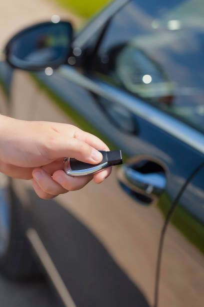 istock Person with an unrecognizable face is holds a car key 2199542173