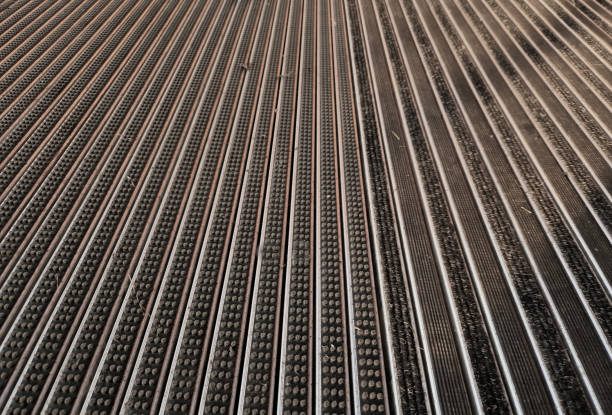 mat with felt filling and cassette brushes, gray aluminium. profiles embedded below the pavement level. replaceable felt brushes clean the shoes and soak up the water. the risk of slipping is reduced, plank, outdoor