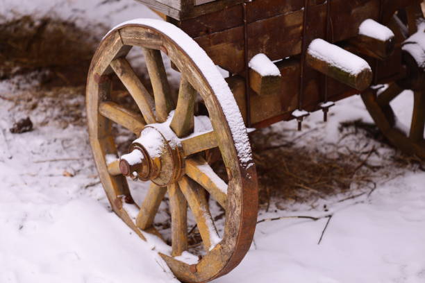 istock A rustic old wooden wagon covered in snow, great for winter scenes or rustic settings 2199544361